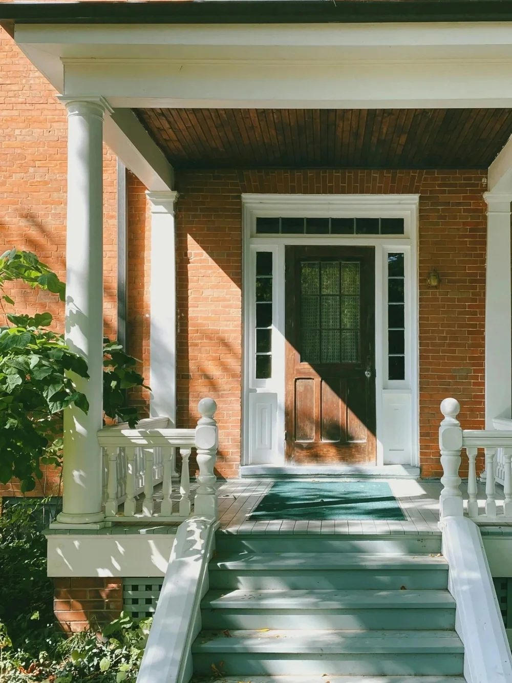 A brick house with a columned front porch in Akron Ohio