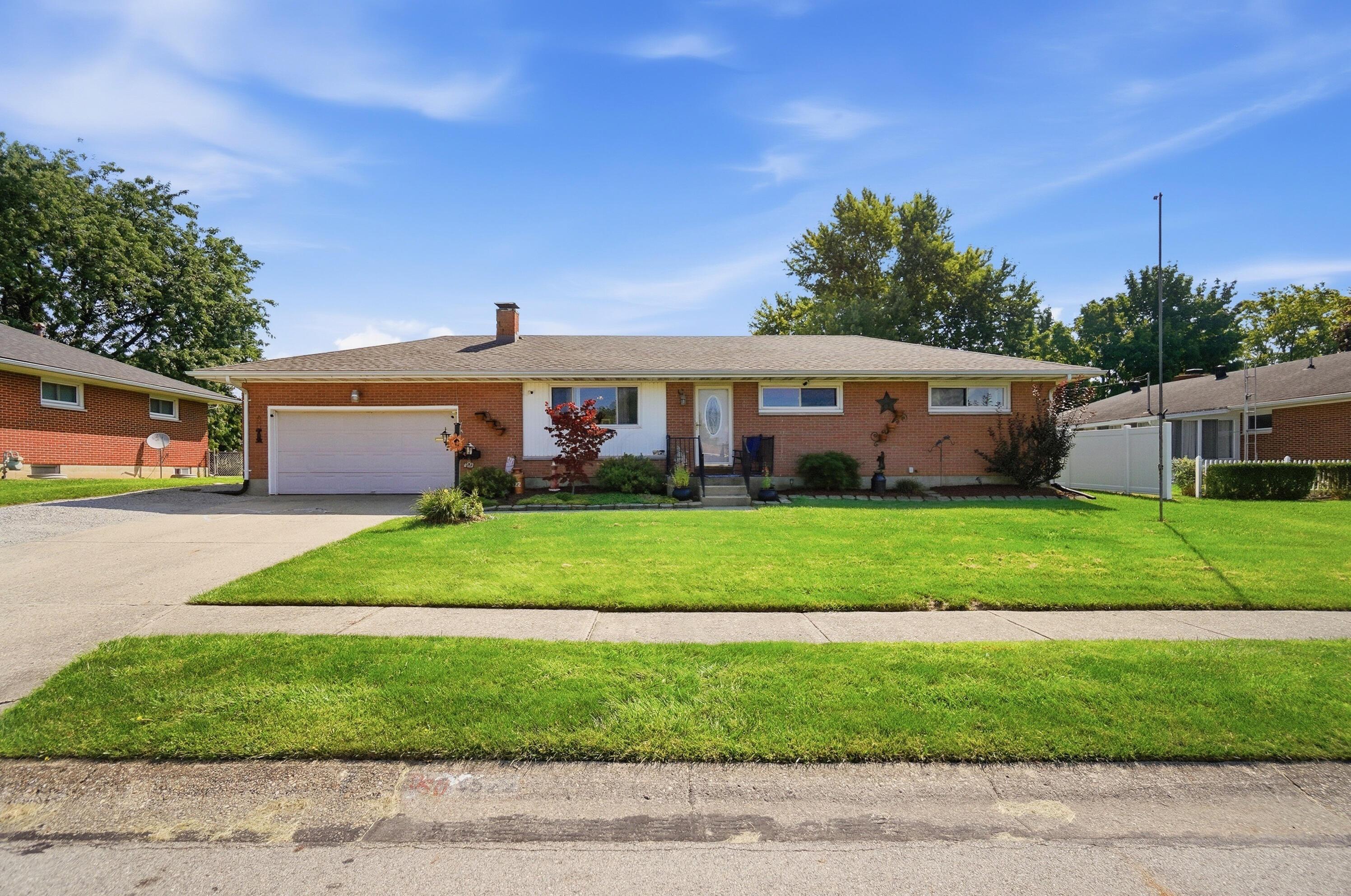 A brick ranch house with a green lawn in Little Rock Arkansas